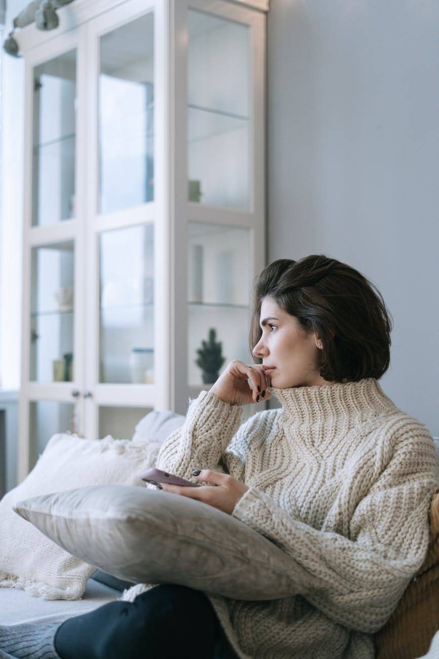 woman looking away while on her phone