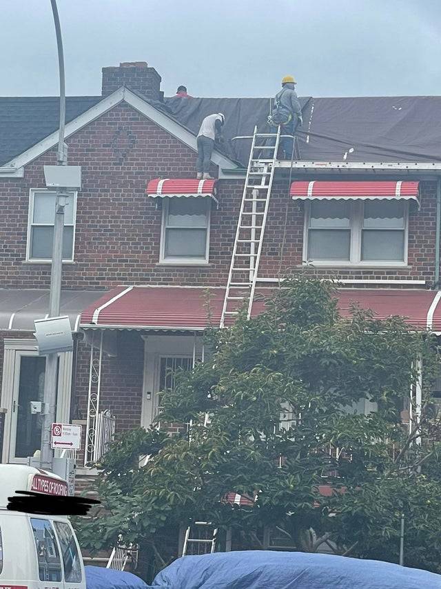 Roofer standing on the top of a window