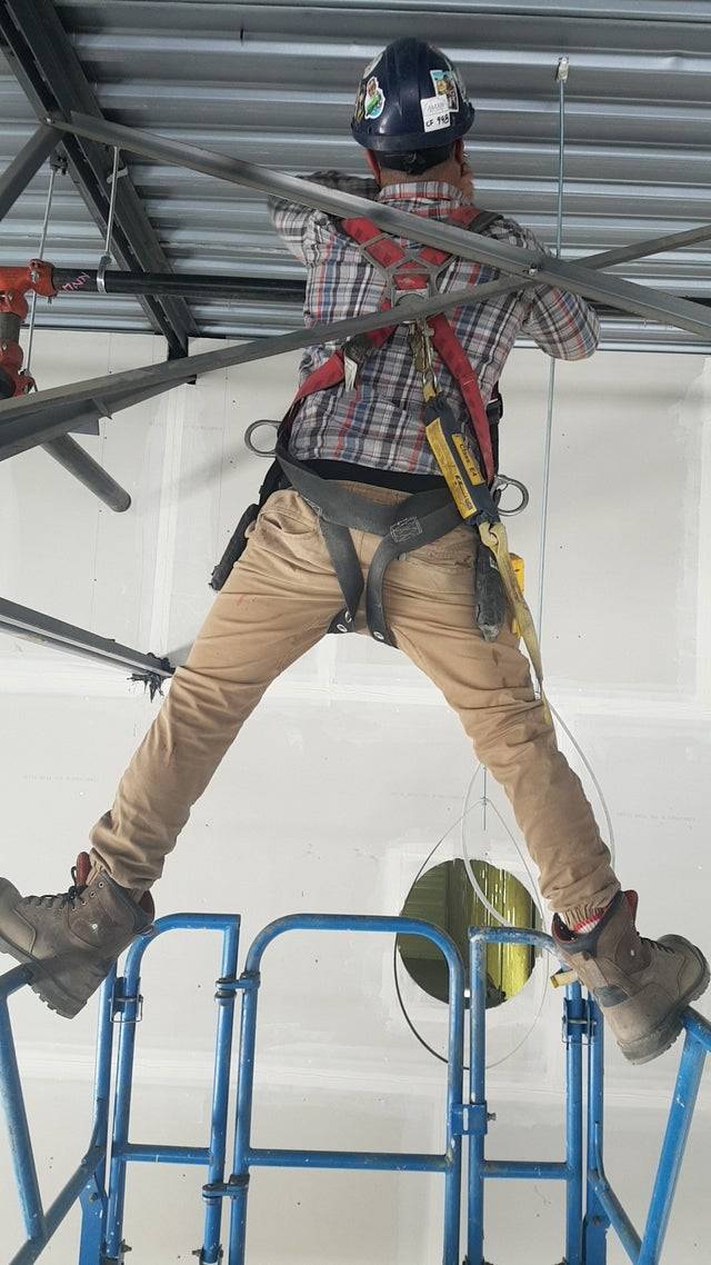 Worker balancing on the top of a lift