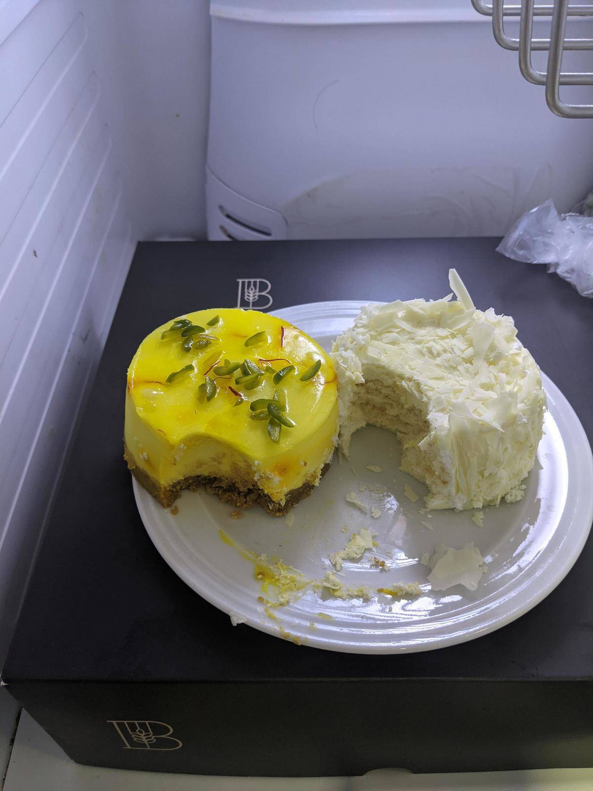 Decorative cakes both with large spoonfuls missing