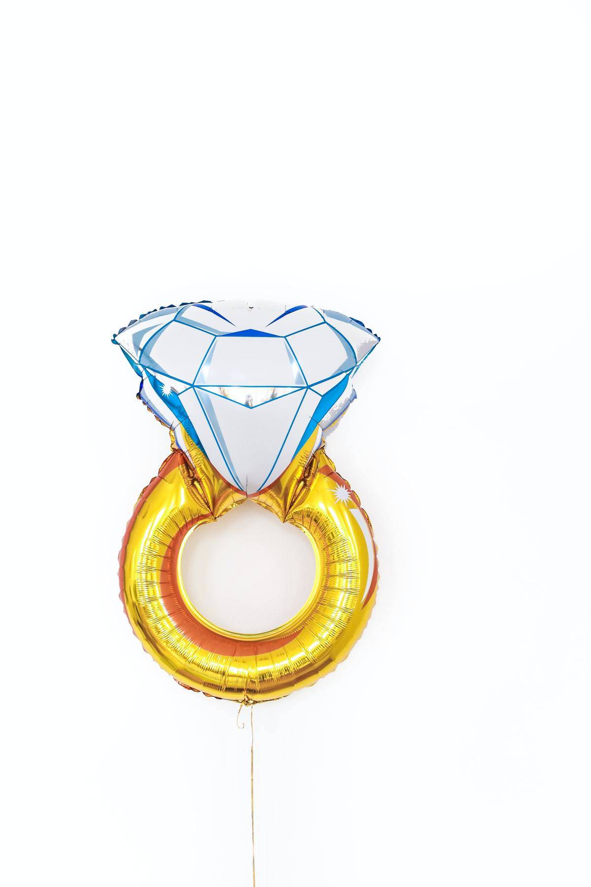 A large balloon of a gold and diamond engagement ring.