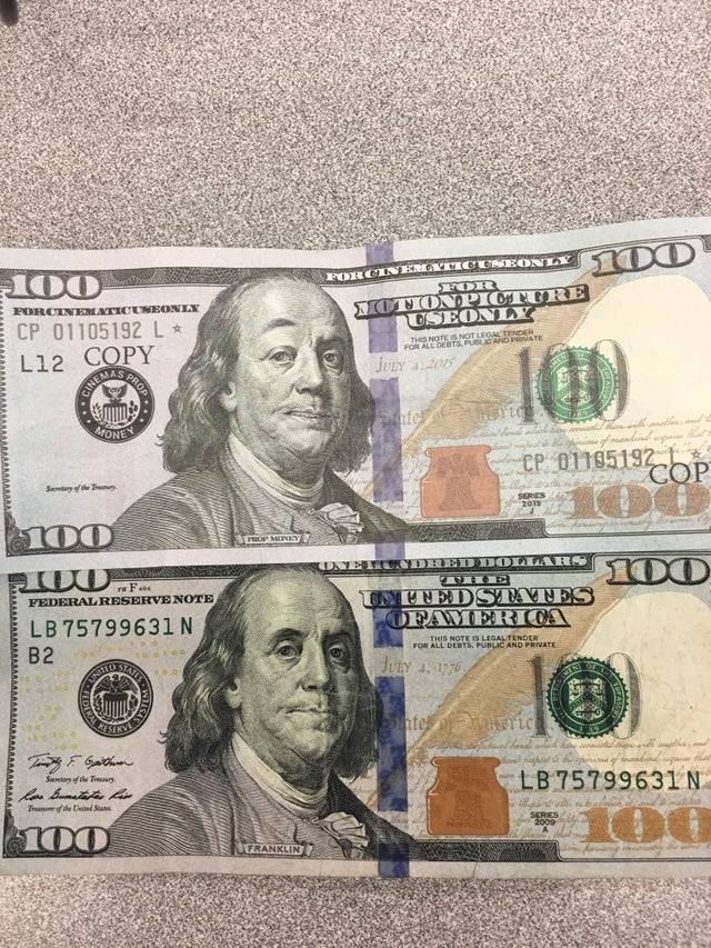 Fake and real U.S. $100 bills side by side