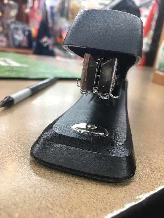 Jammed up stapler sitting on desk