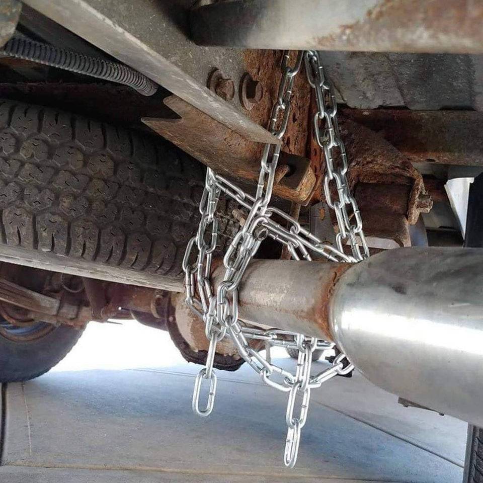 Muffler being held up by a metal chain