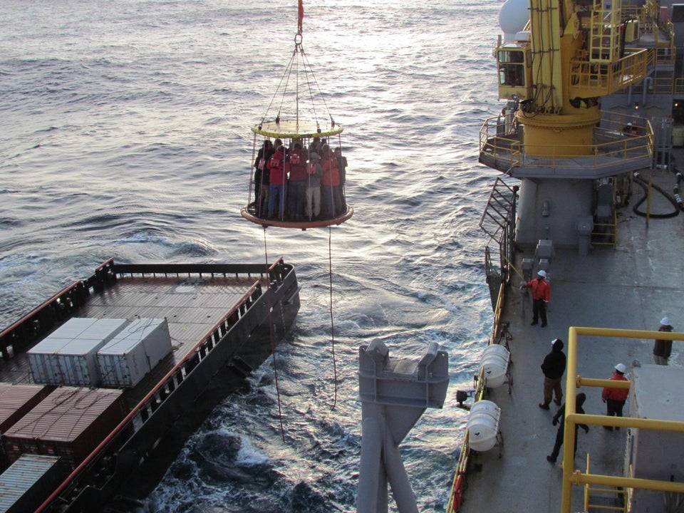 People crowded on a platform over the water