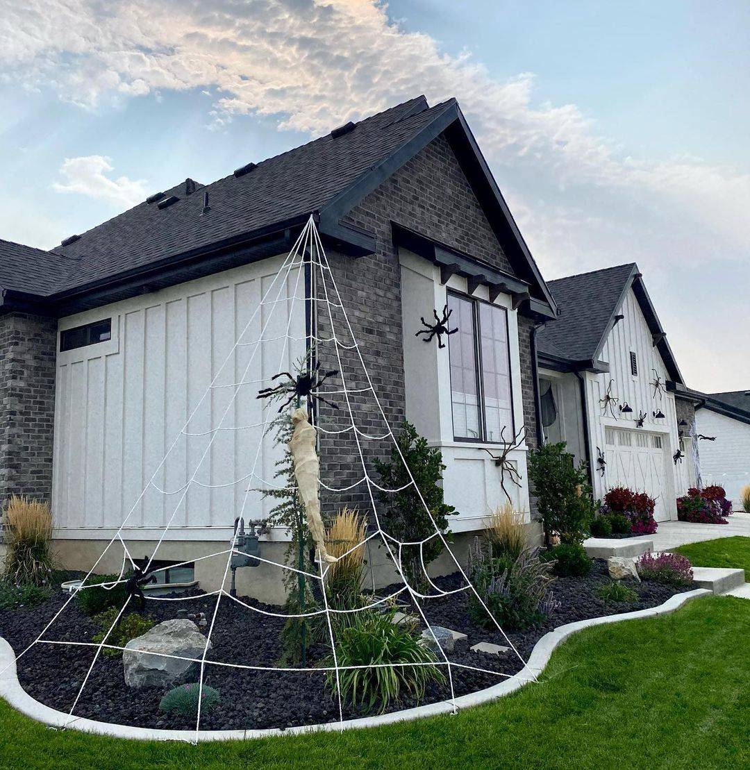 Spider web made of rope attached to house for Halloween