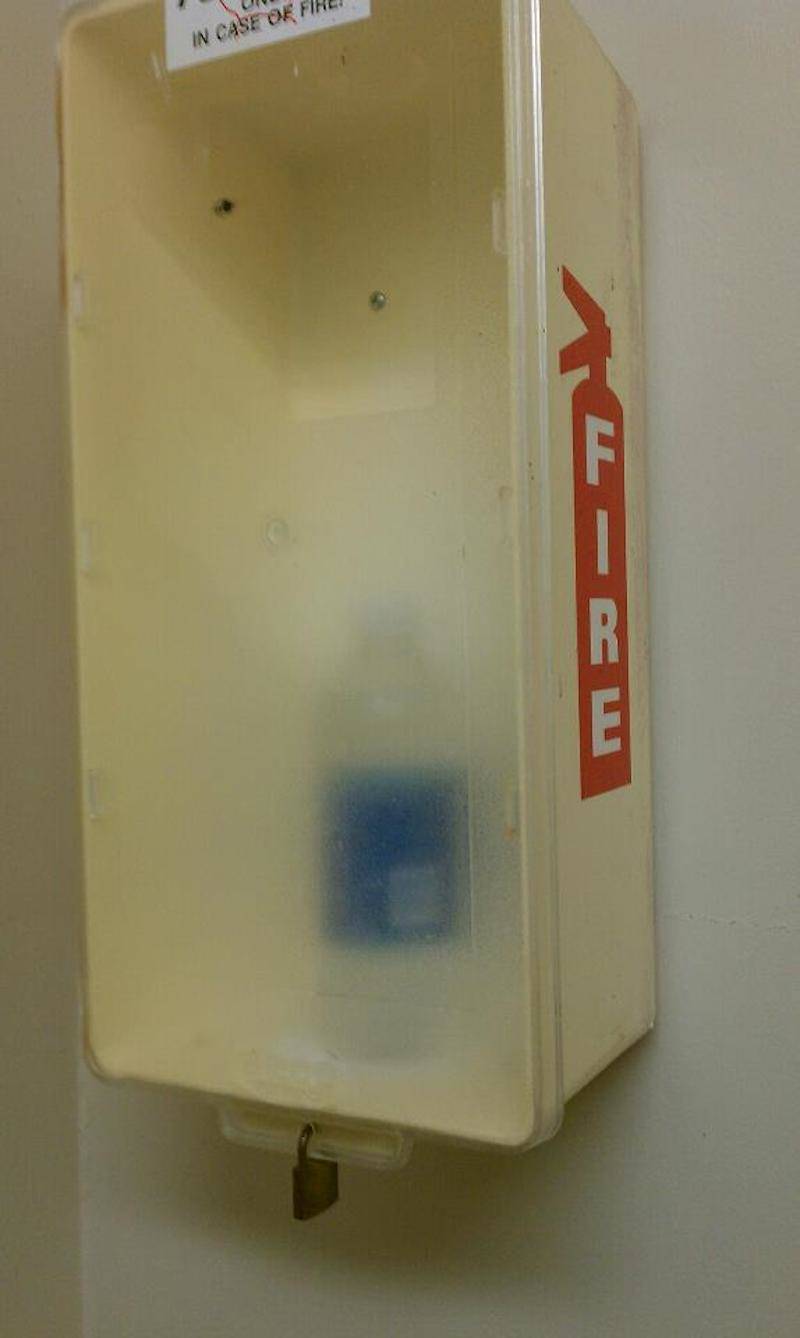 A water bottle where a fire extinguisher should rest