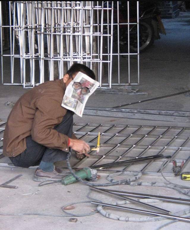 Man using piece of paper as a welding mask