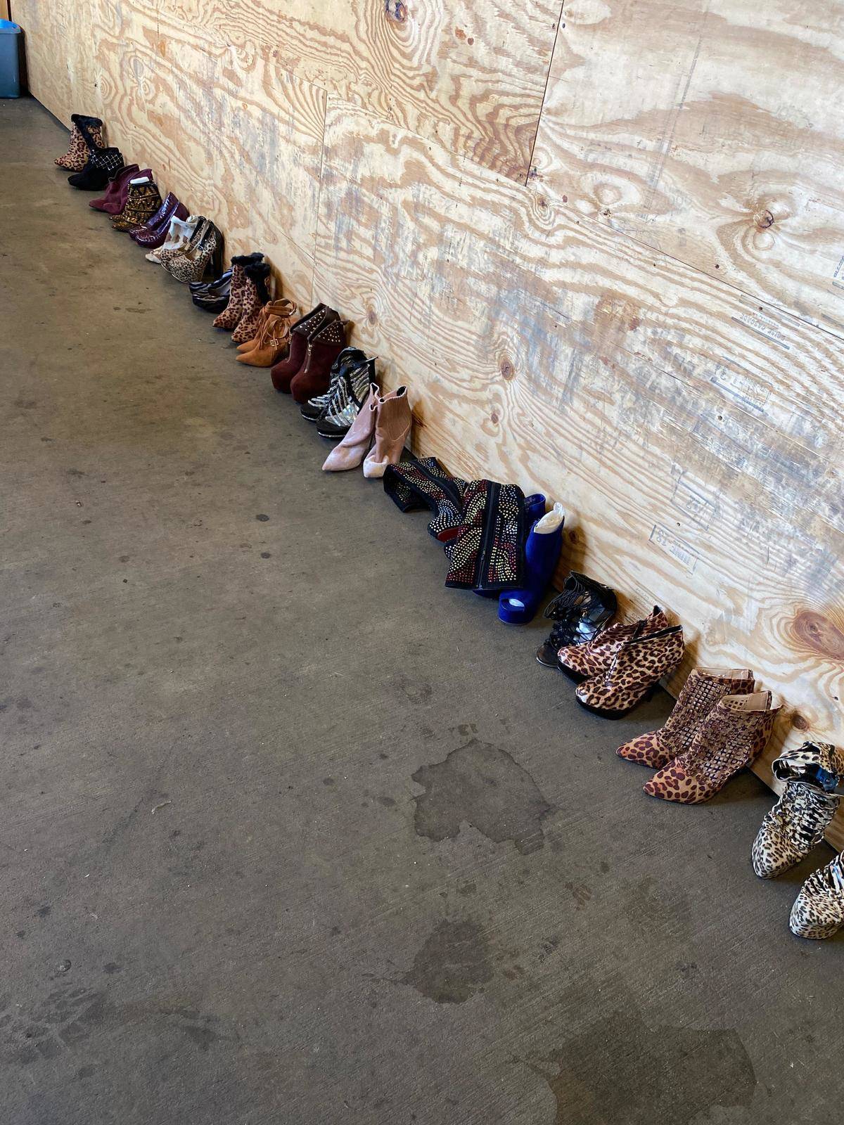 Line of woman's shoes against wood board