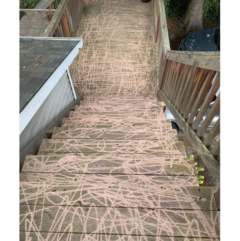 stairs and a deck that have been poorly power washed so there are lines everywhere
