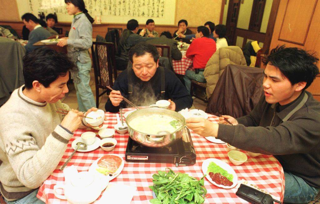 people eating at a table in China