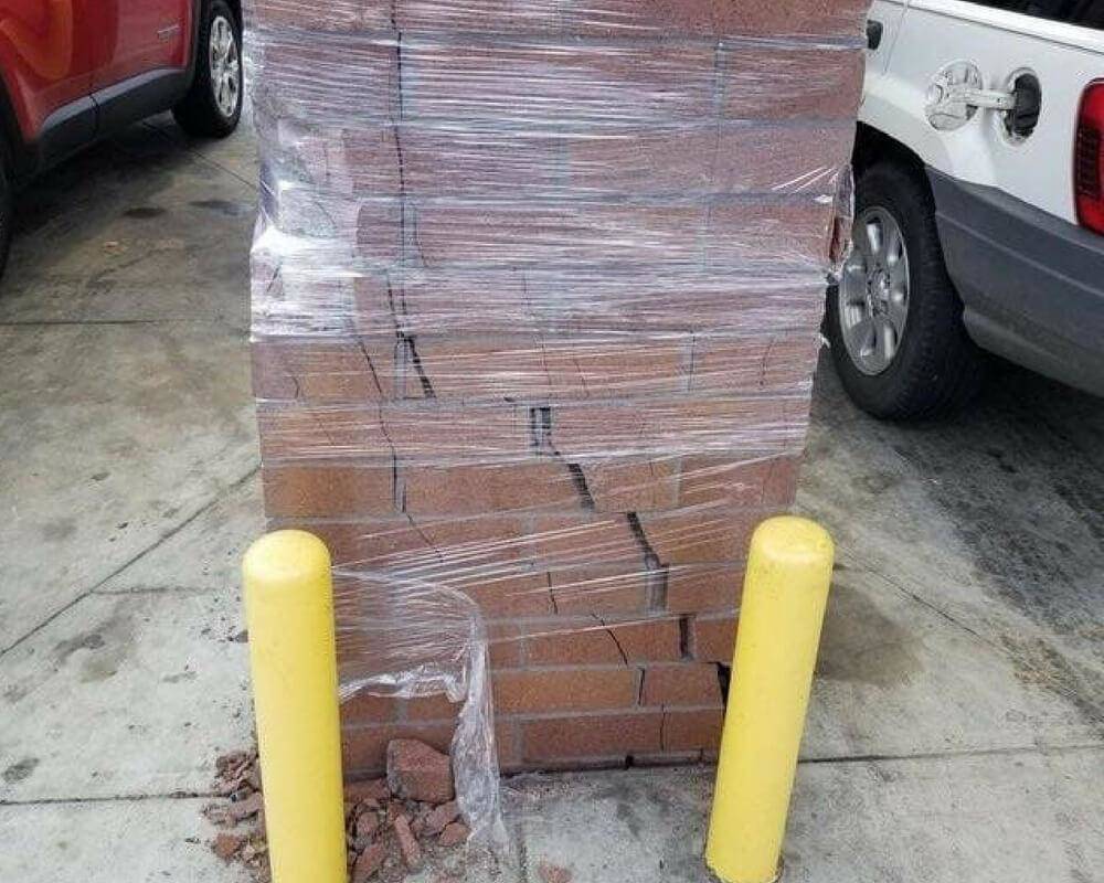 cracked brick pillar held together by saran wrap