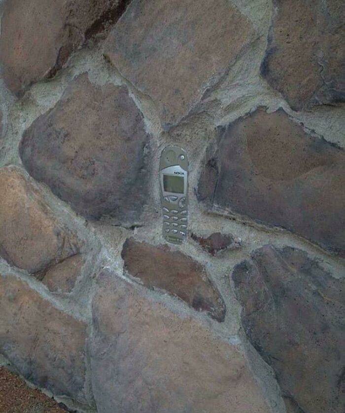 phone in stone of building