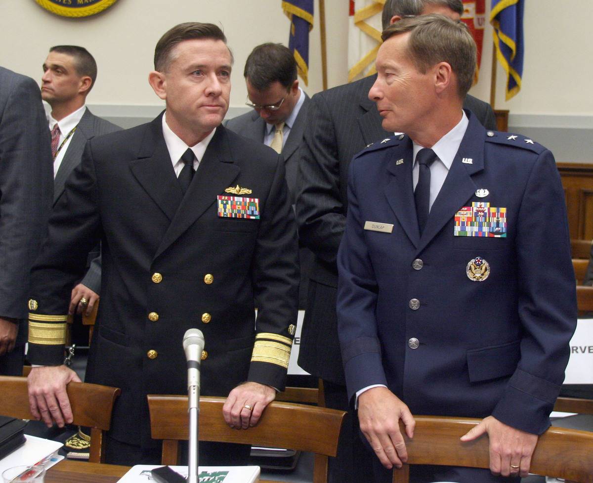 Rear Admiral Bruce E. MacDonald, left, judge advocate genera