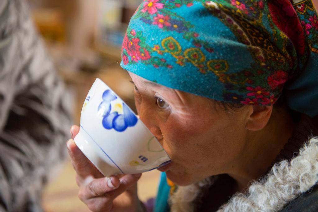 Close-up of a Kazakh woman drinking traditional suutei tsai