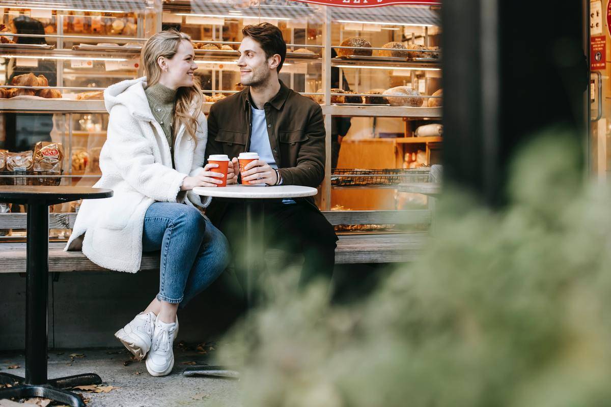 Couple on bench outside bakery