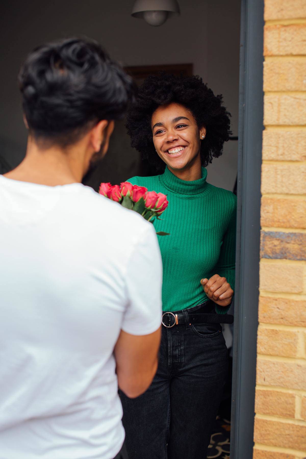 Man brings flowers to woman