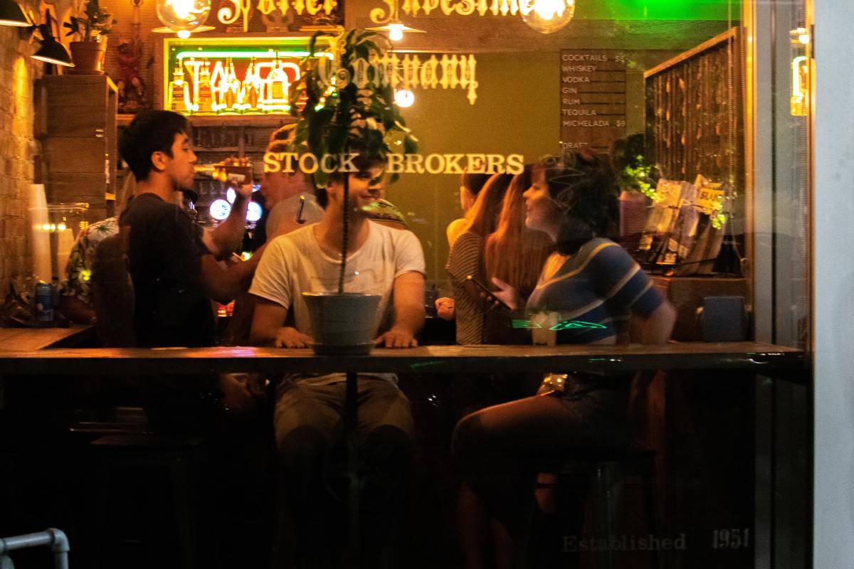 Two people in restaurant; woman faces man