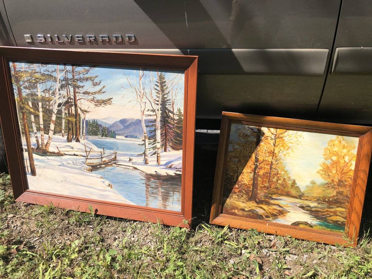 Oil paintings leaning against a truck