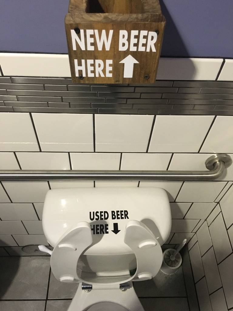 Local brewery bathroom with shelf for holding beer