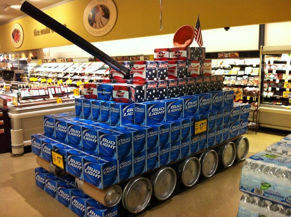 Beer cases arranged in grocery store to look like a tank