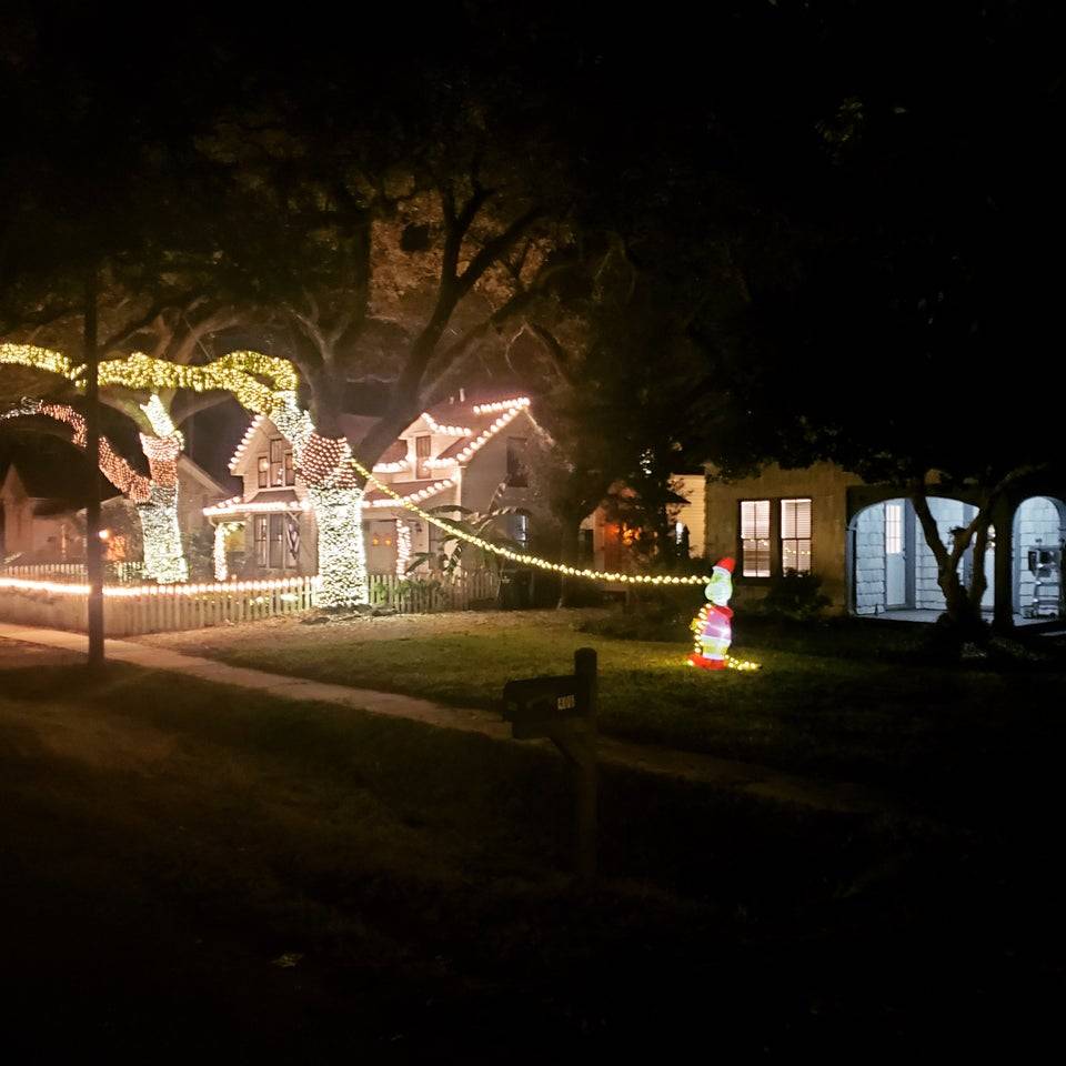 A house decorated with extravagant Christmas lights, and his next-door neighbor's small contribution.