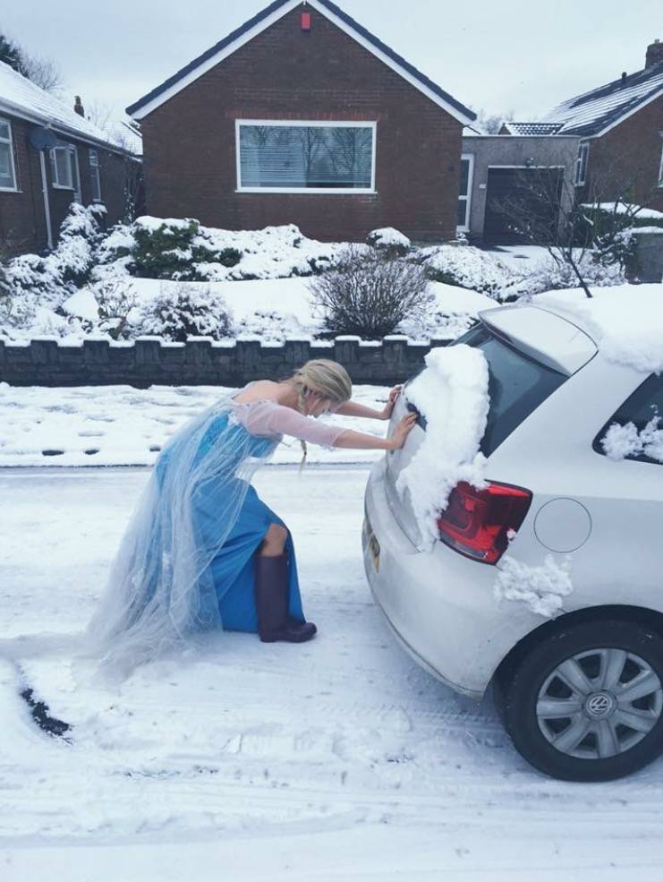 Woman dressed as Elsa pushing car in snow
