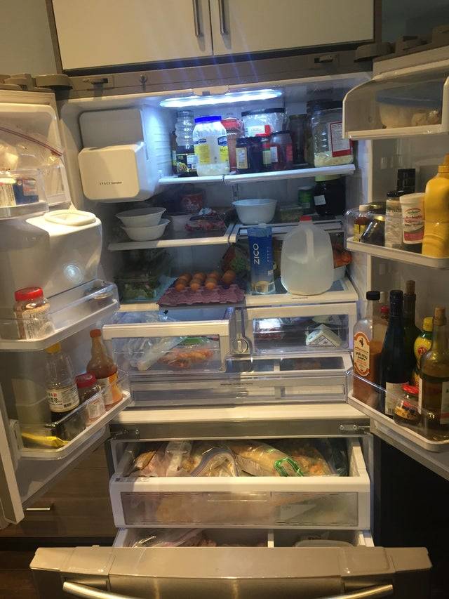 Open fridge filled with food.