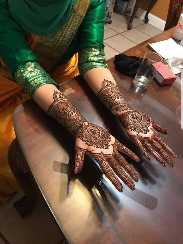 Woman with henna tattoos on her hands and wrists. 