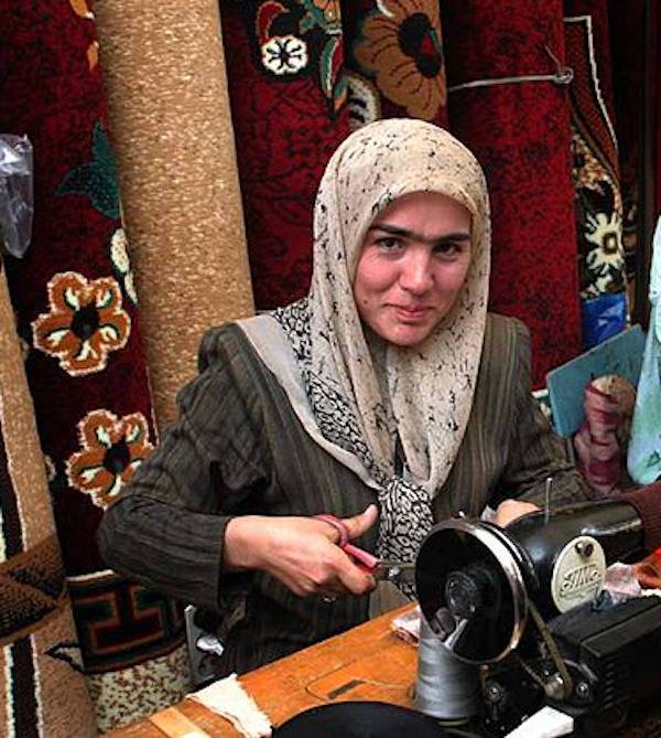 Woman with a monobrow looking into the camera. 