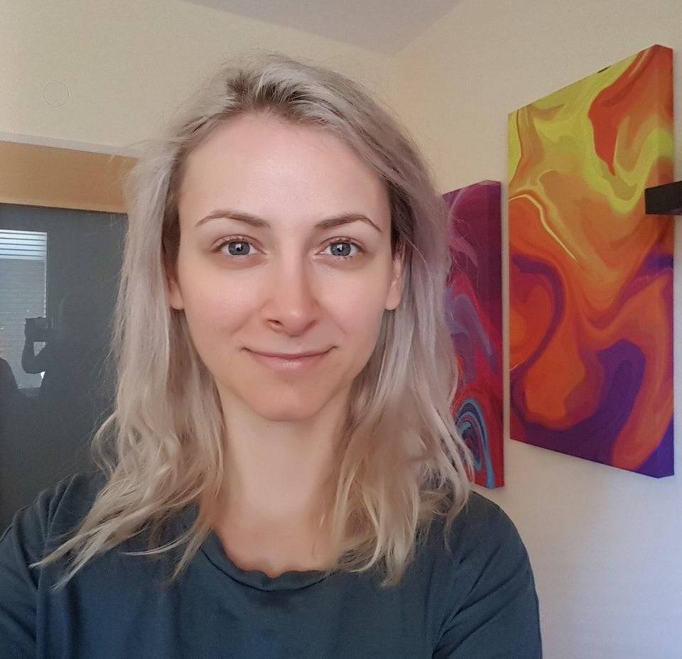 Blonde haired woman looking into the camera. 