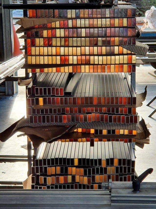 shelves of aluminum tubing look golden because of light shining through
