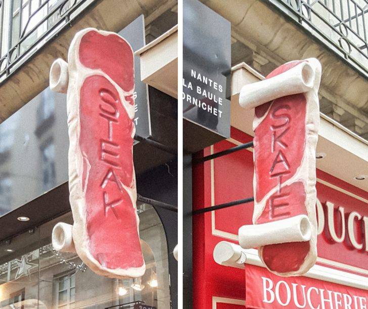 Steak and skateboard shops side by side share a wall sign