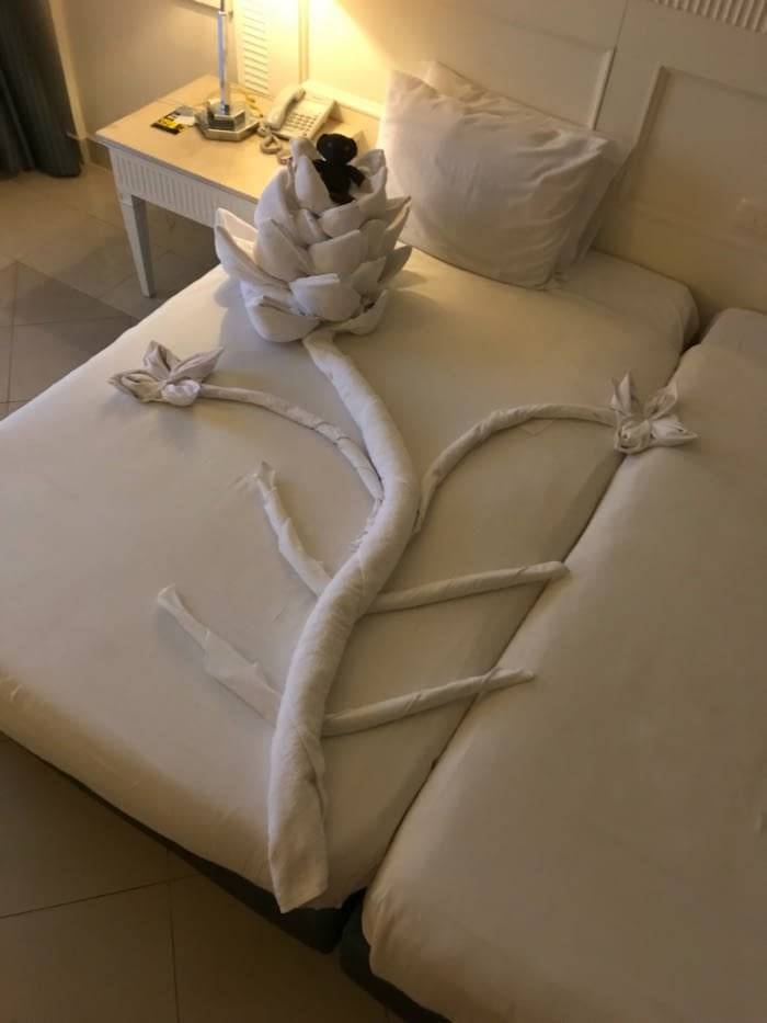 Elaborate towel artwork on hotel bed