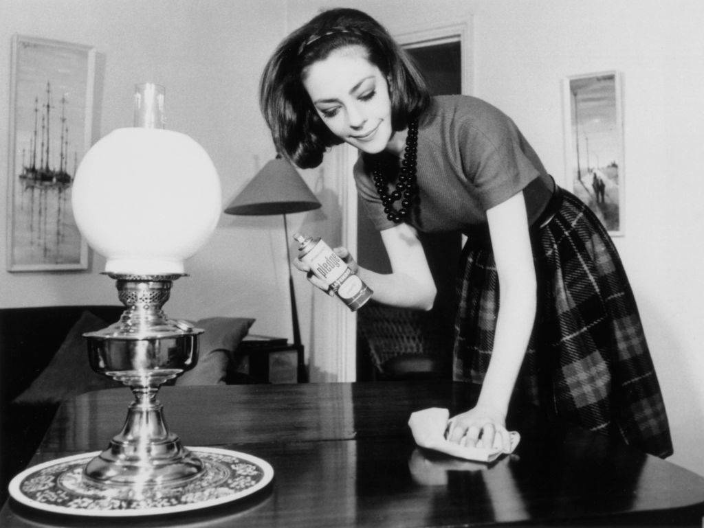 Woman polishing the living room table