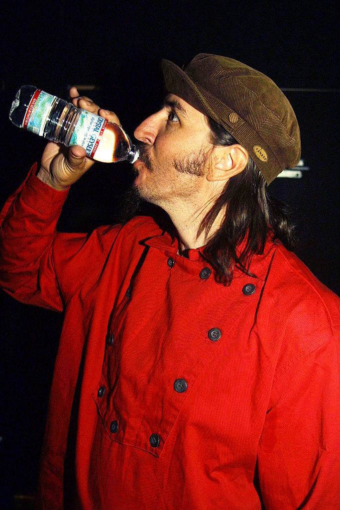 man drinking from a water bottle