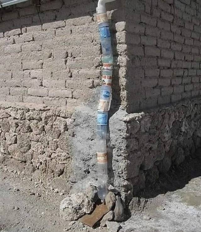 Homemade downpipe made out of containers. 