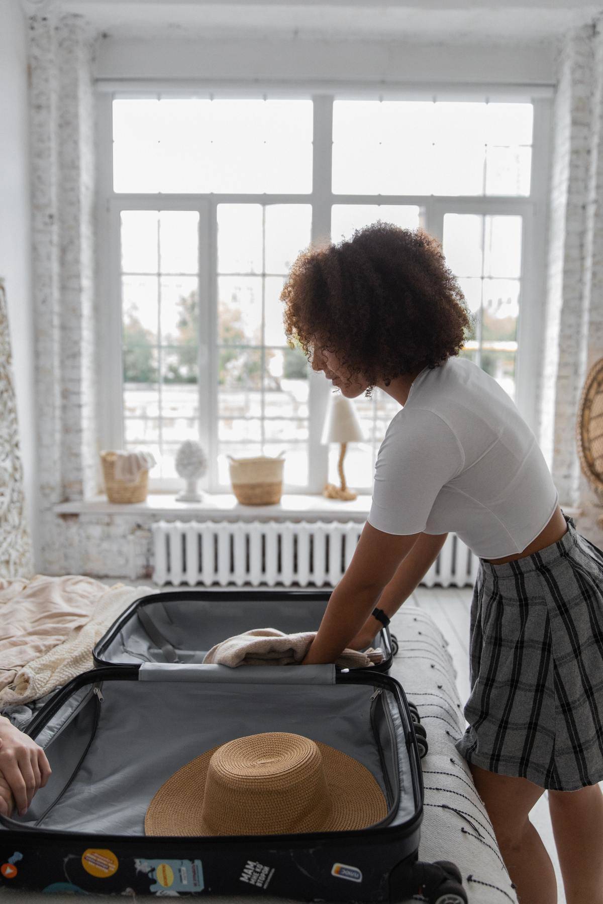 A woman packs a suitcase
