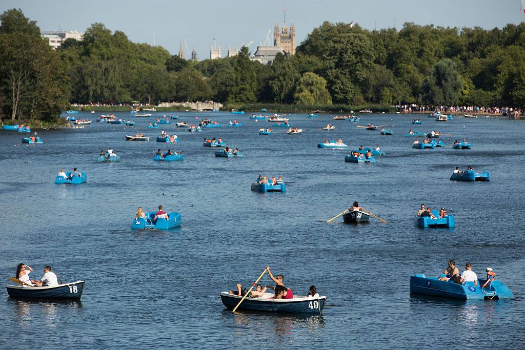 People row boats on the Serpentine lake in Hyde Park