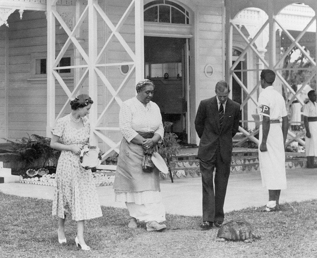 the queen with prince philip and queen of tonga and a tortoise