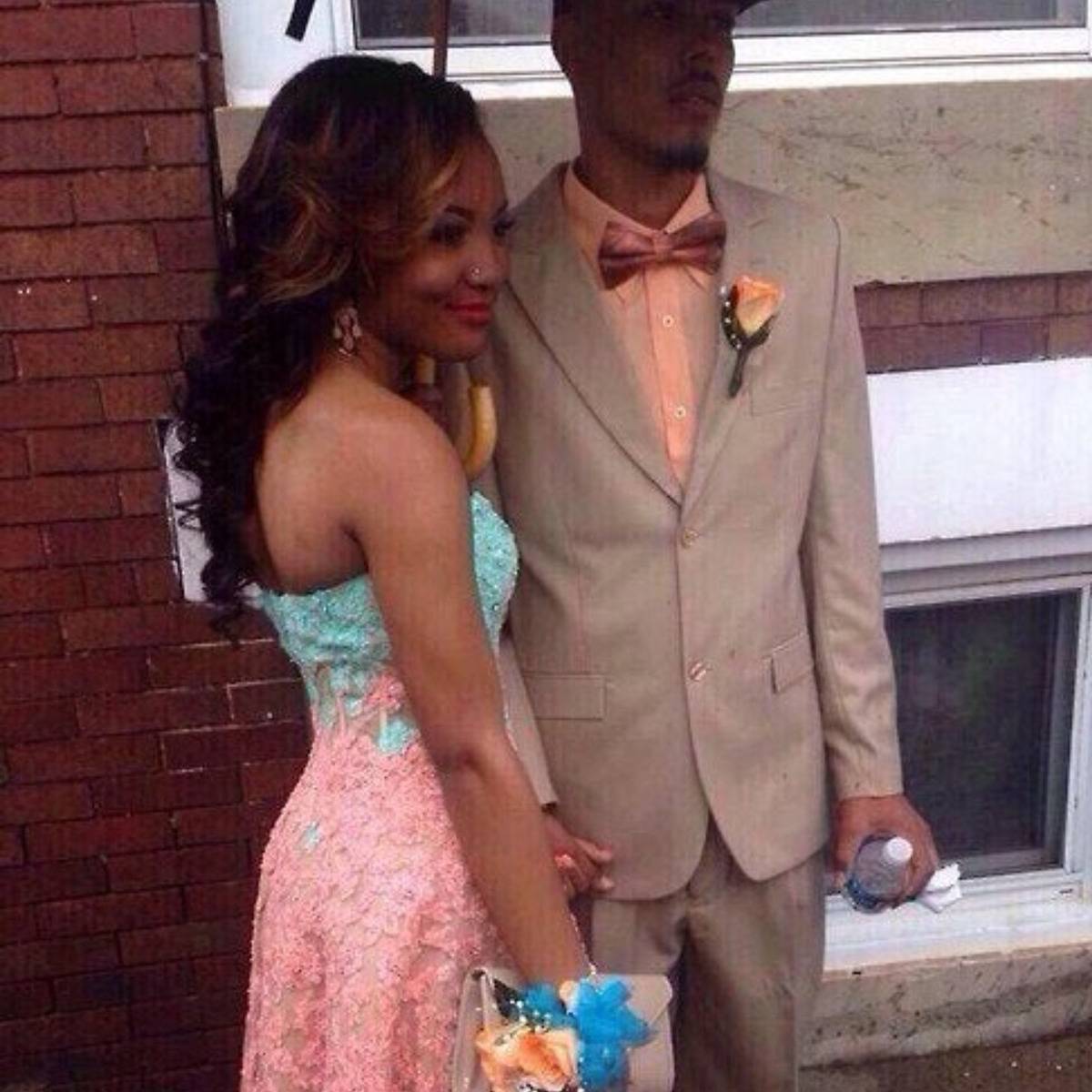 extra hand appears to be holding the umbrella between the couple