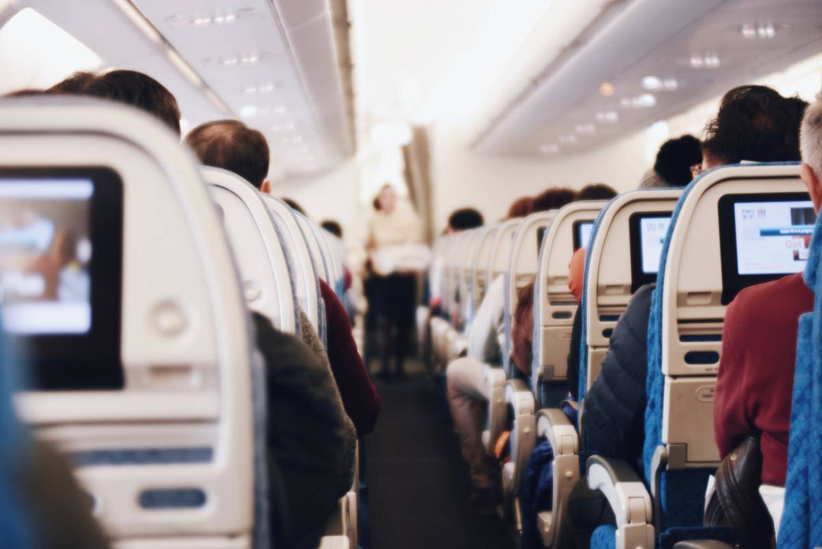 An airplane cabin looking down the aisle.