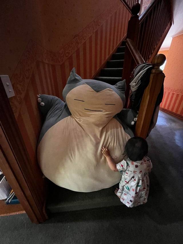 Makeshift baby gate using large Pokémon stuffed animal