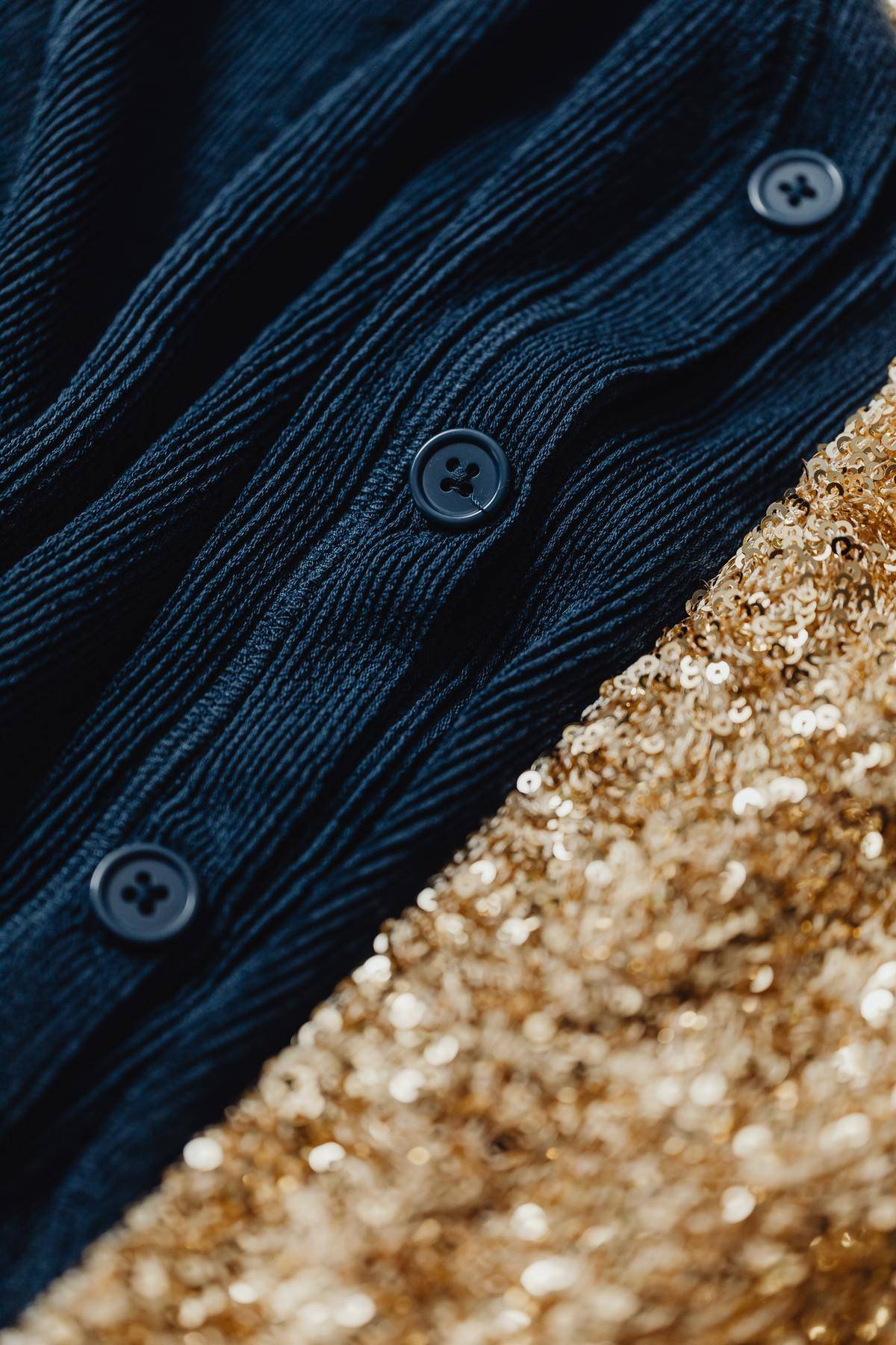 Blue buttons on a navy blue sweater.