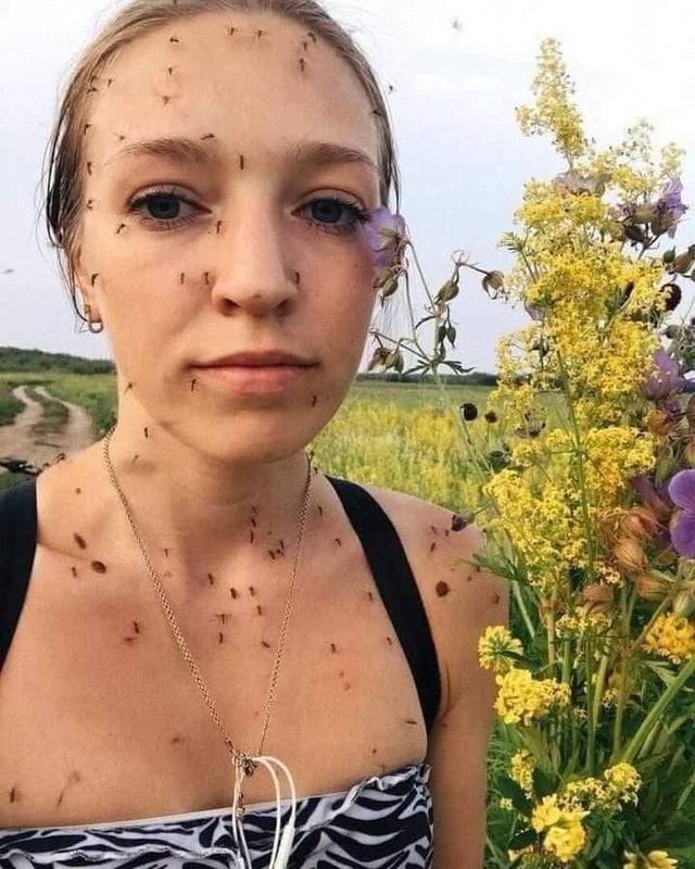 Woman outside covered in bugs