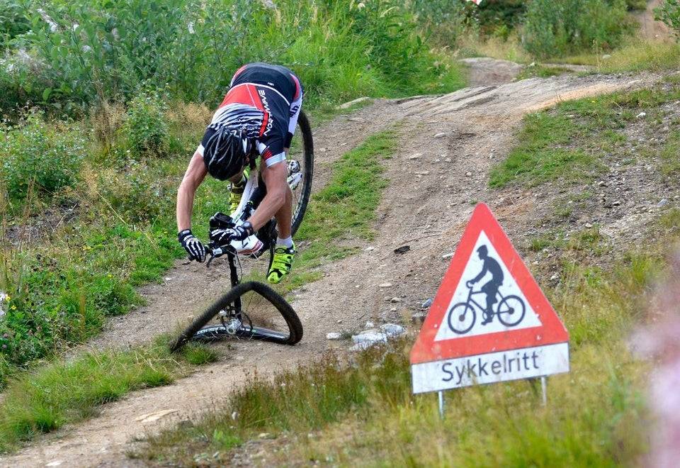 Mountain biker with crashed wheel and about to fall over handlebars. 