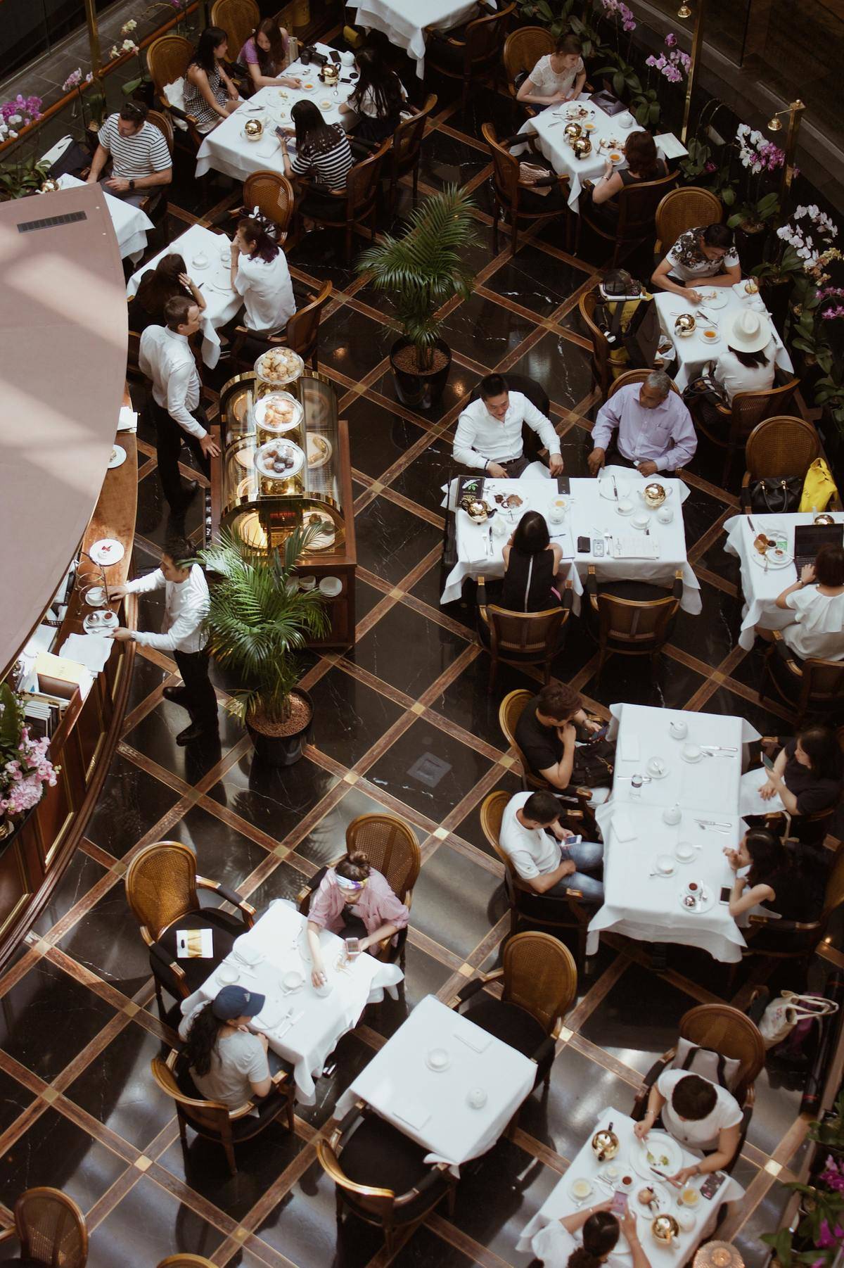 Busy restaurant with many tables filled.