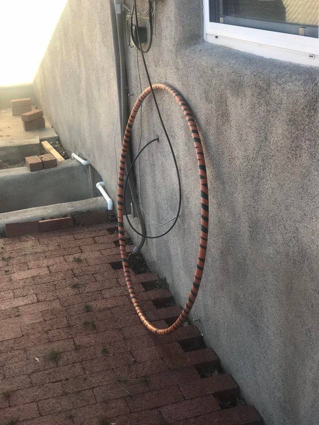 Cable guy installed the wire through a hoola hoop leaned in the yard