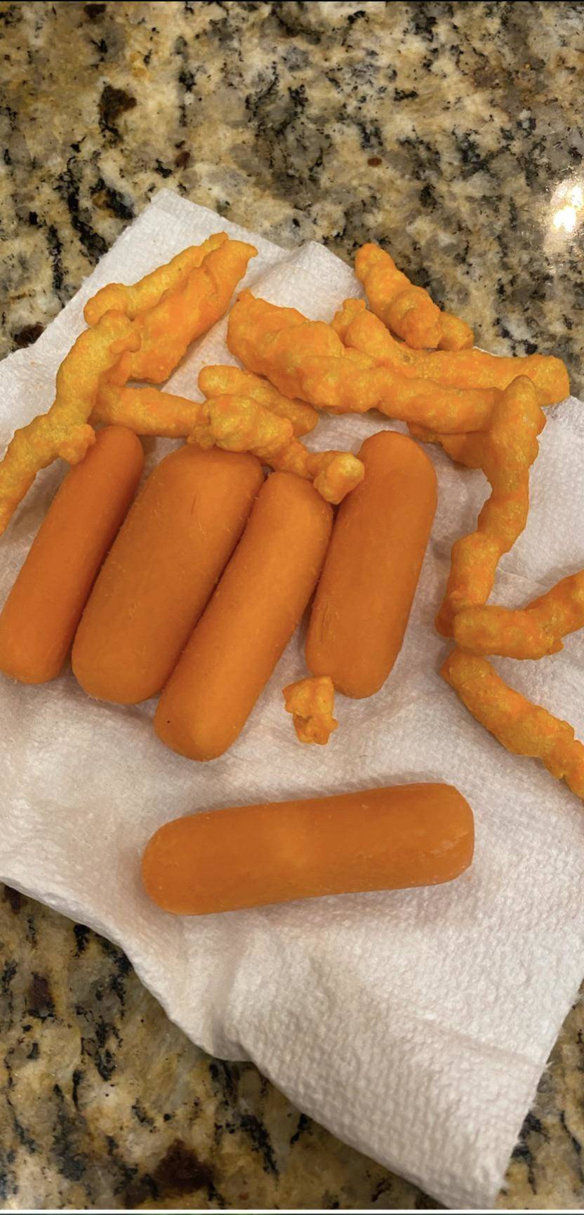 Carrots and Cheetos on a paper towel  
