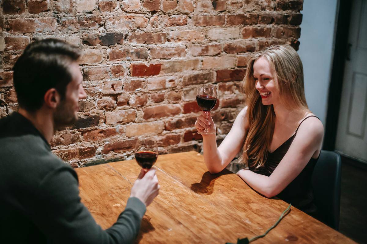 Couple chatting over wine on a date night